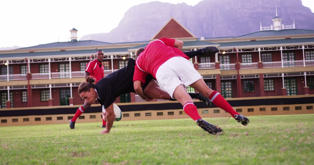 Dynamic Rugby Tackle on Field Behind School