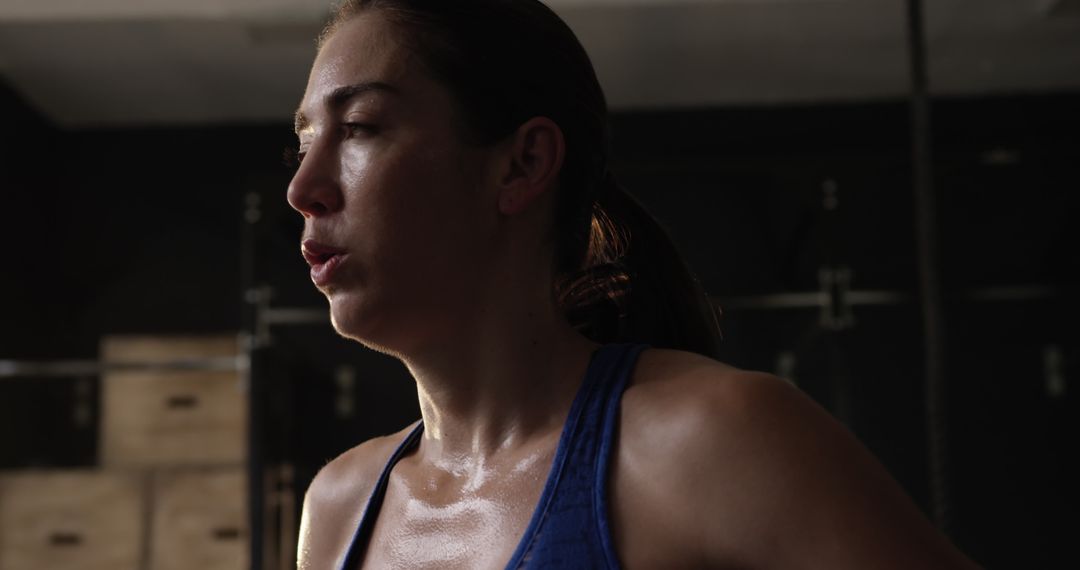 Sweaty Fit Woman Resting After Intense Workout in Gym