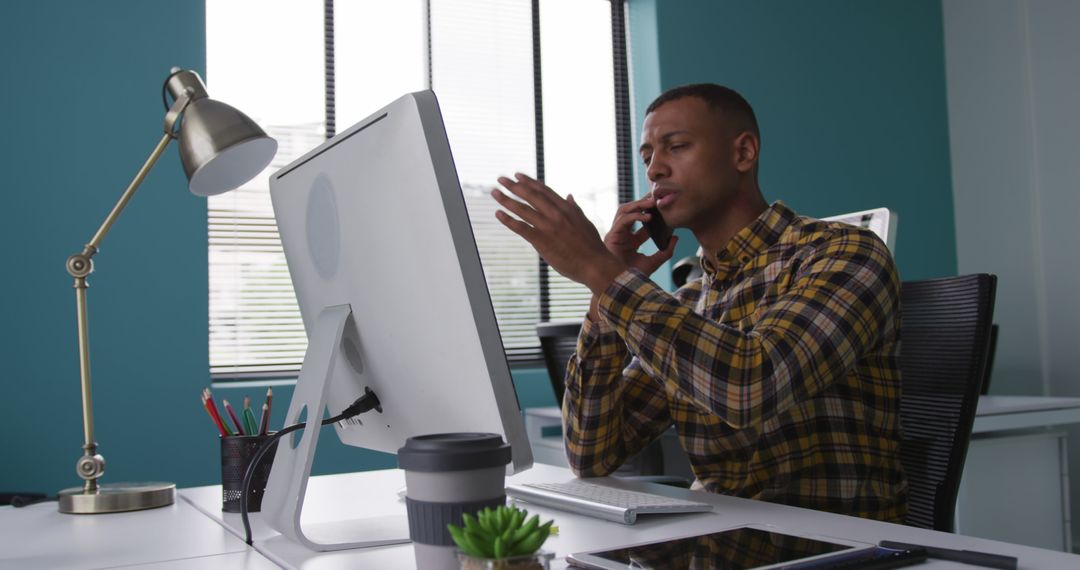 Young Professional Solving a Problem on Phone while Using Computer - Free Images, Stock Photos and Pictures on Pikwizard.com