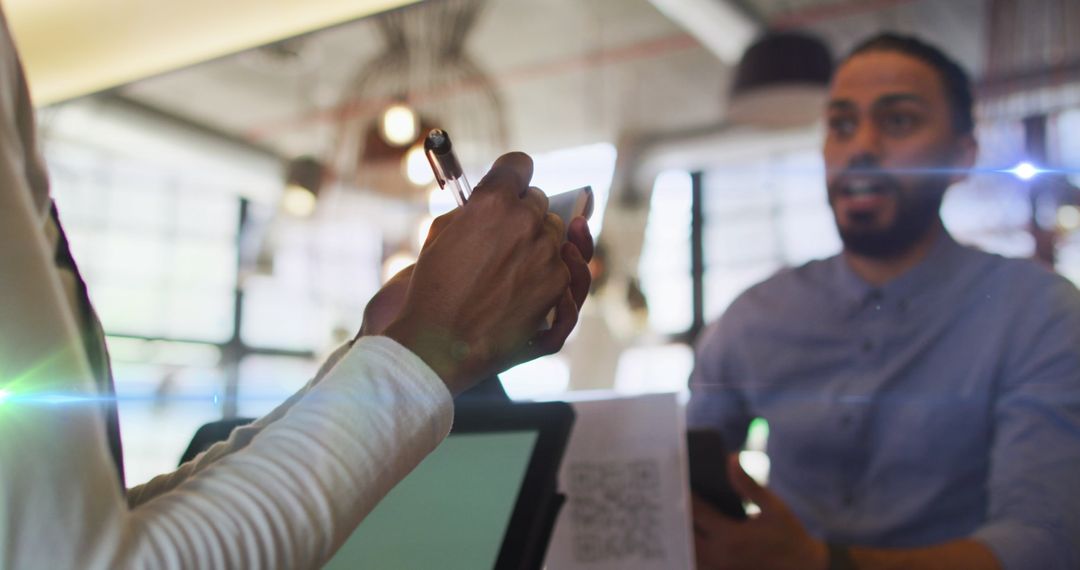 Man Ordering Coffee in Modern Cafe with Technology Integration