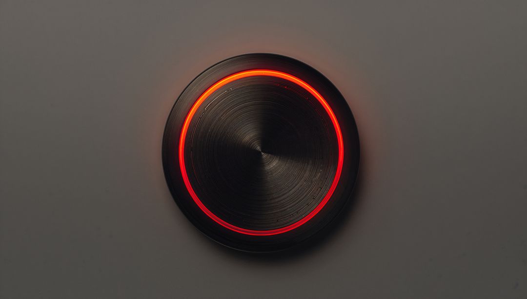 Glowing Brushed Metal Knob with Red-Orange LED Ring Casting Halo on Light-Gray Panel