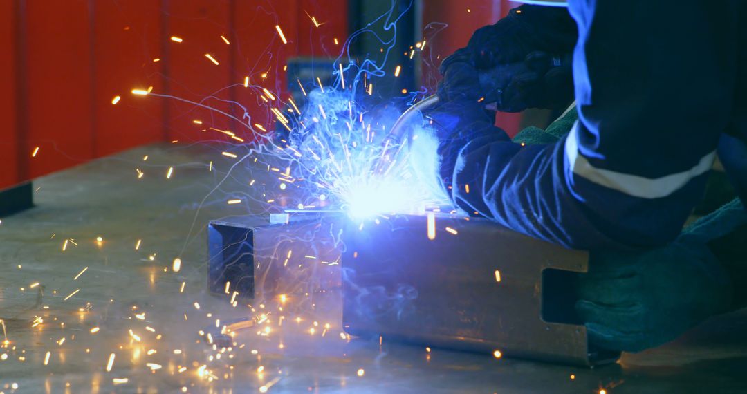 Welder Working with a Bright Blue Electric Arc and Sparks - Free Images, Stock Photos and Pictures on Pikwizard.com