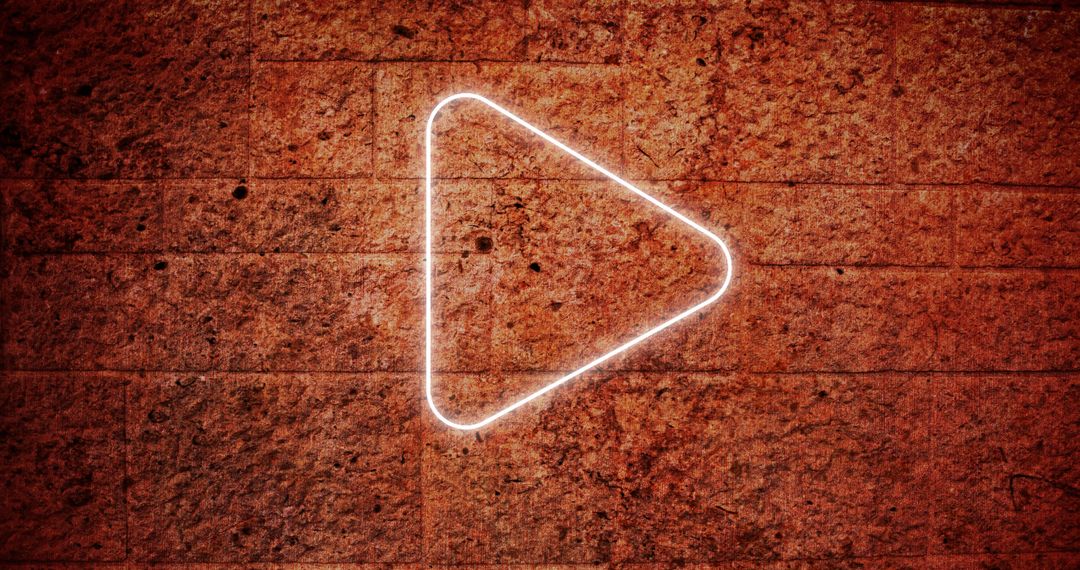 Illuminated Play Button Icon on Textured Grunge Wall