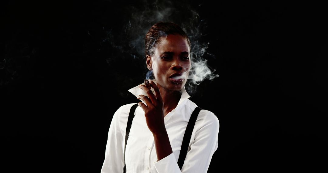 Confident Woman Smoking in White Shirt against Black Background - Free Images, Stock Photos and Pictures on Pikwizard.com