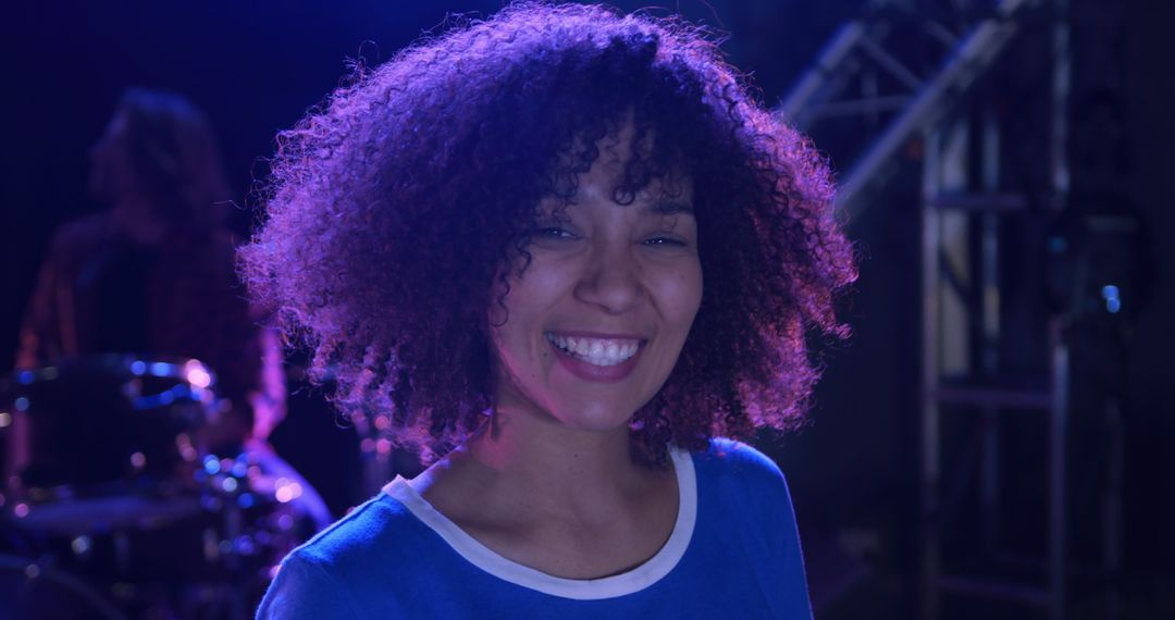 Smiling Woman with Curly Hair at Music Event - Free Images, Stock Photos and Pictures on Pikwizard.com