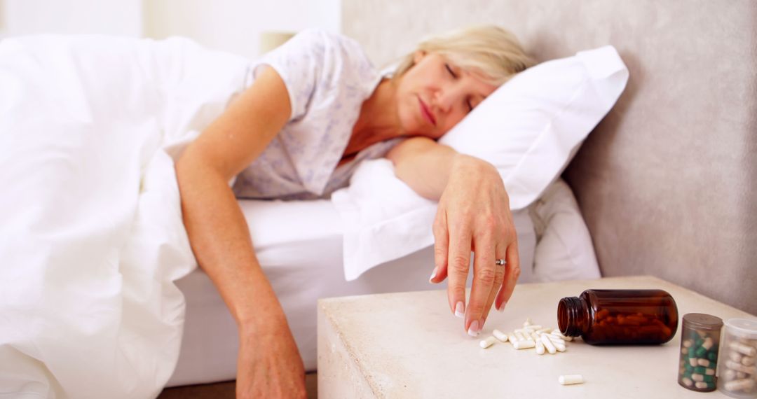 Woman lying motionless after overdose of pills at home in bedroom - Free Images, Stock Photos and Pictures on Pikwizard.com