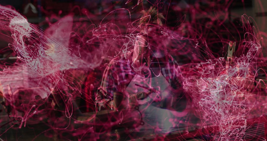 Metalworker Using Tools in Workshop Amidst Dynamic Light Trails