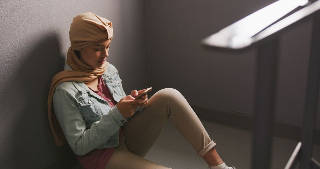 Young Woman in Hijab Relaxing and Using Smartphone - Free Images, Stock Photos and Pictures on Pikwizard.com