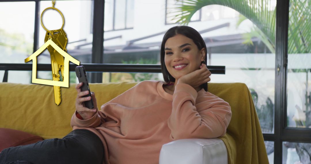 Happy Woman Relaxing at Home with Mobile and House Key Symbol