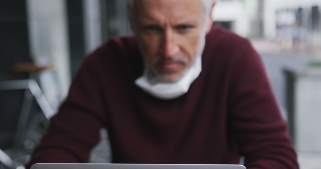 Older Man Focused on Laptop in Café Setting - Free Images, Stock Photos and Pictures on Pikwizard.com