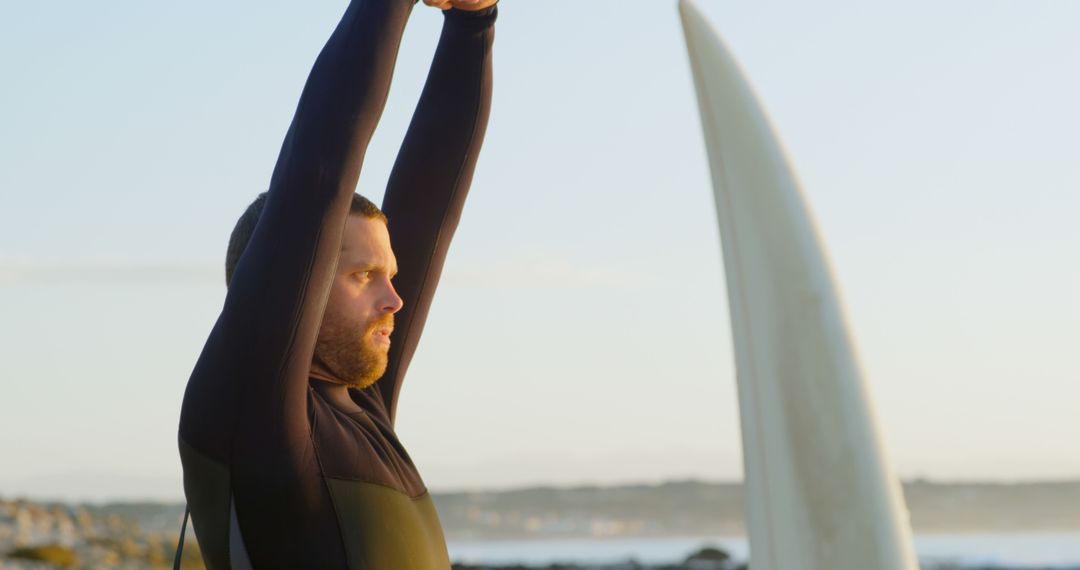 Surfer Stretching on Beach at Sunrise - Free Images, Stock Photos and Pictures on Pikwizard.com