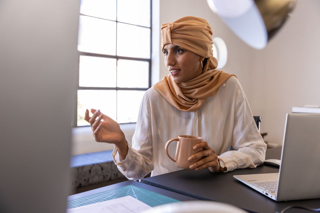 Creative Entrepreneur Engaged in Design Discussion at Modern Workspace