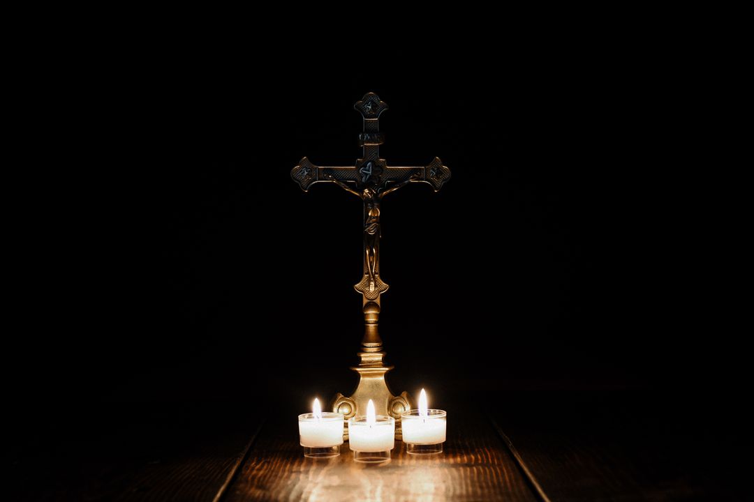 Bronze Cross with Burning Candles on Dark Background - Free Images, Stock Photos and Pictures on Pikwizard.com