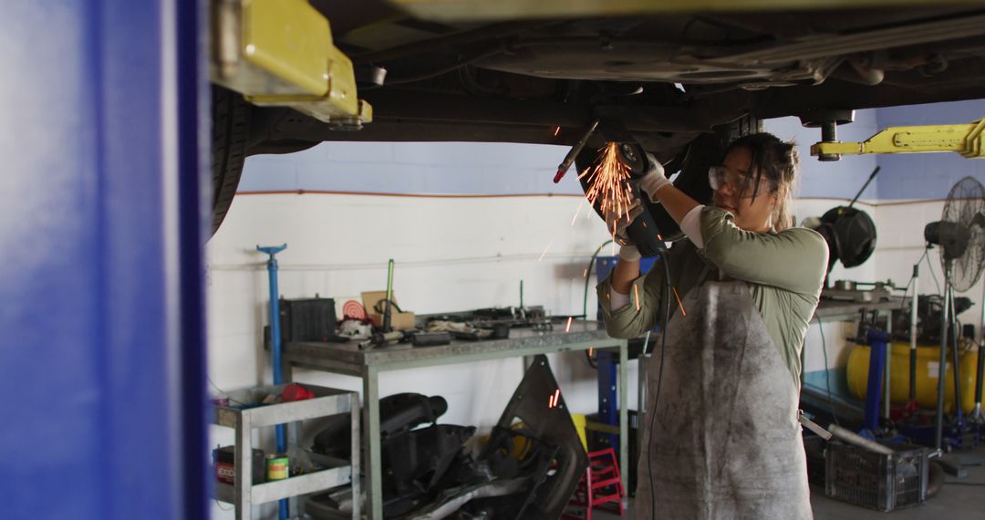 Female Mechanic Welding Under Car in Automotive Workshop - Free Images, Stock Photos and Pictures on Pikwizard.com