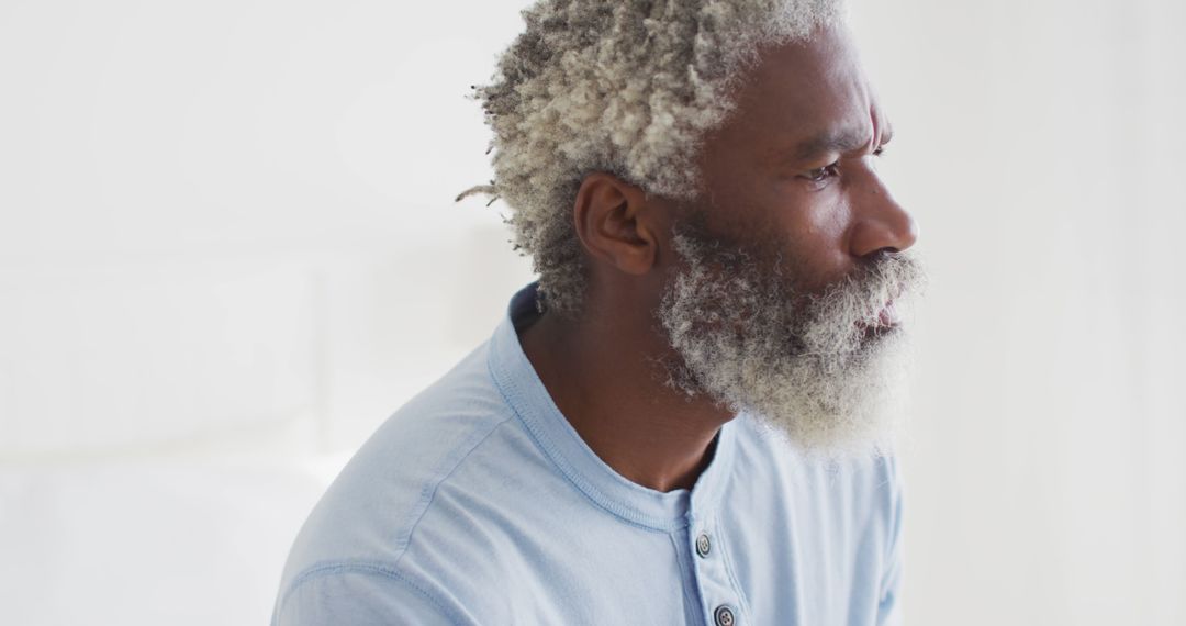 Thoughtful Senior Man with Gray Hair in Serene Home Setting