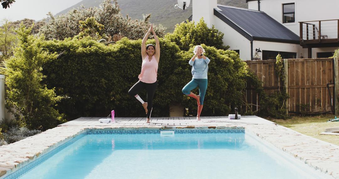 Two Women Practicing Yoga Poses by Poolside in Outdoor Garden - Free Images, Stock Photos and Pictures on Pikwizard.com