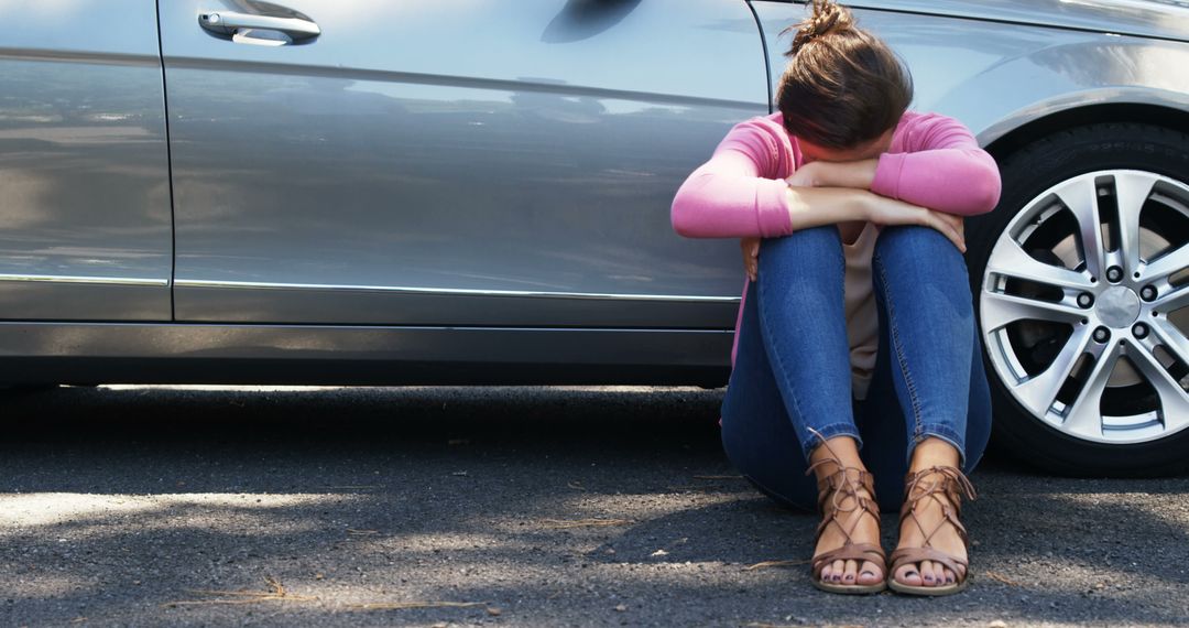 Distressed Young Woman Sitting Next to Car - Free Images, Stock Photos and Pictures on Pikwizard.com