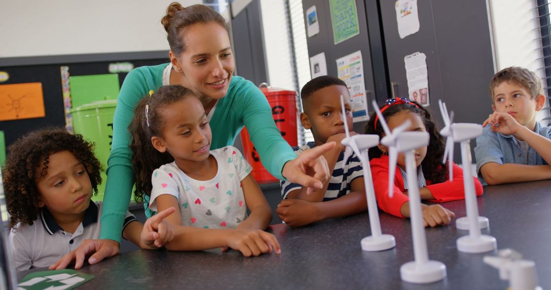Teacher Guiding Students in STEM Activity with Mini Windmills