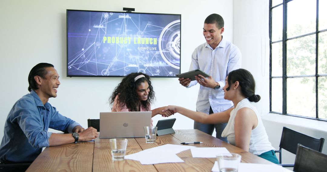 Diverse Team Celebrating Successful Project Launch in Modern Office