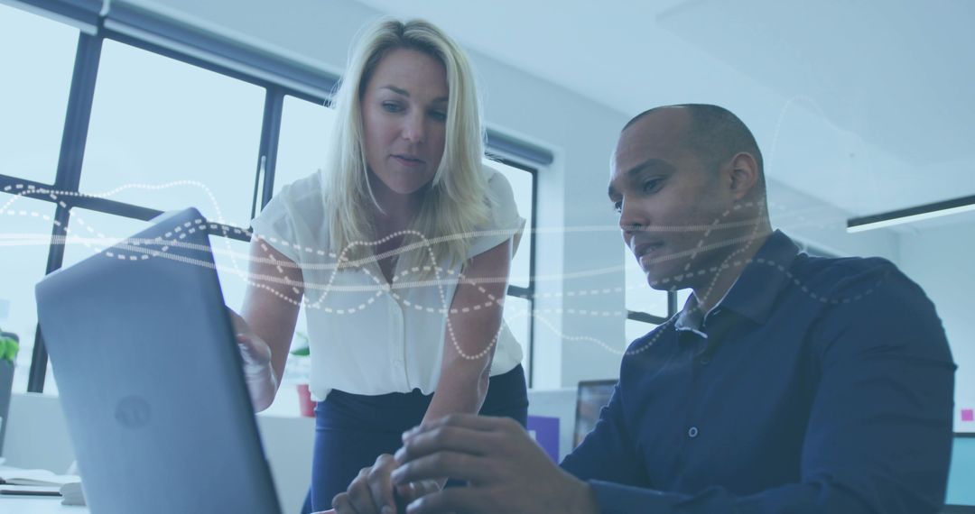 Collaborating on Data Analytics Dashboard, Team Reviewing Insights on Laptop