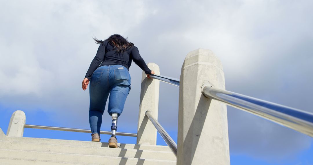 Woman with Prosthetic Leg Going Upstairs Outdoors - Free Images, Stock Photos and Pictures on Pikwizard.com