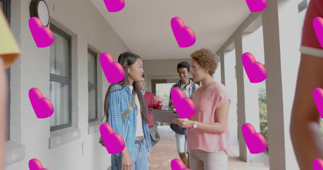 Student Talking with Tutor Holding Tablet in School Hallway with Floating Pink Hearts