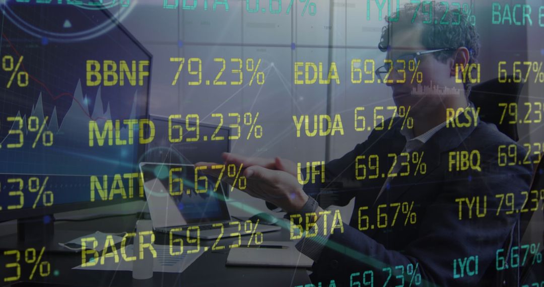 Financial Analyst at Desk Analyzing Stock Data on Dual Monitors