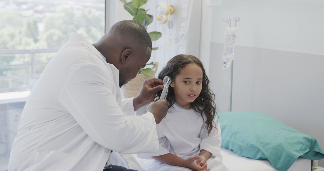 Pediatrician Examining Young Girl with Otoscope in Hospital Room - Free Images, Stock Photos and Pictures on Pikwizard.com