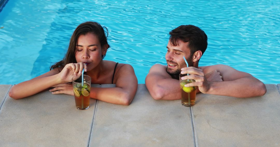 Couple Enjoying Refreshing Beverages at Poolside - Free Images, Stock Photos and Pictures on Pikwizard.com