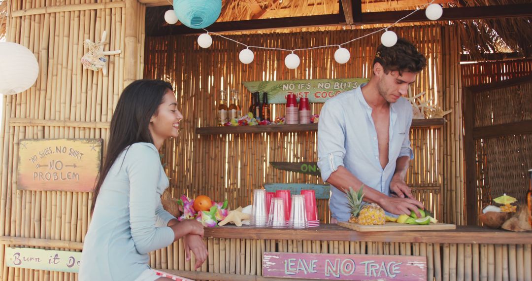 Young Couple Preparing Fresh Cocktails at Beach Bar - Free Images, Stock Photos and Pictures on Pikwizard.com