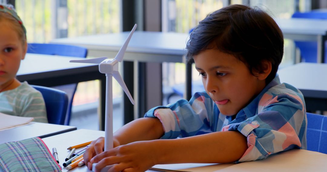 Curious Schoolboy Exploring Wind Energy in Classroom