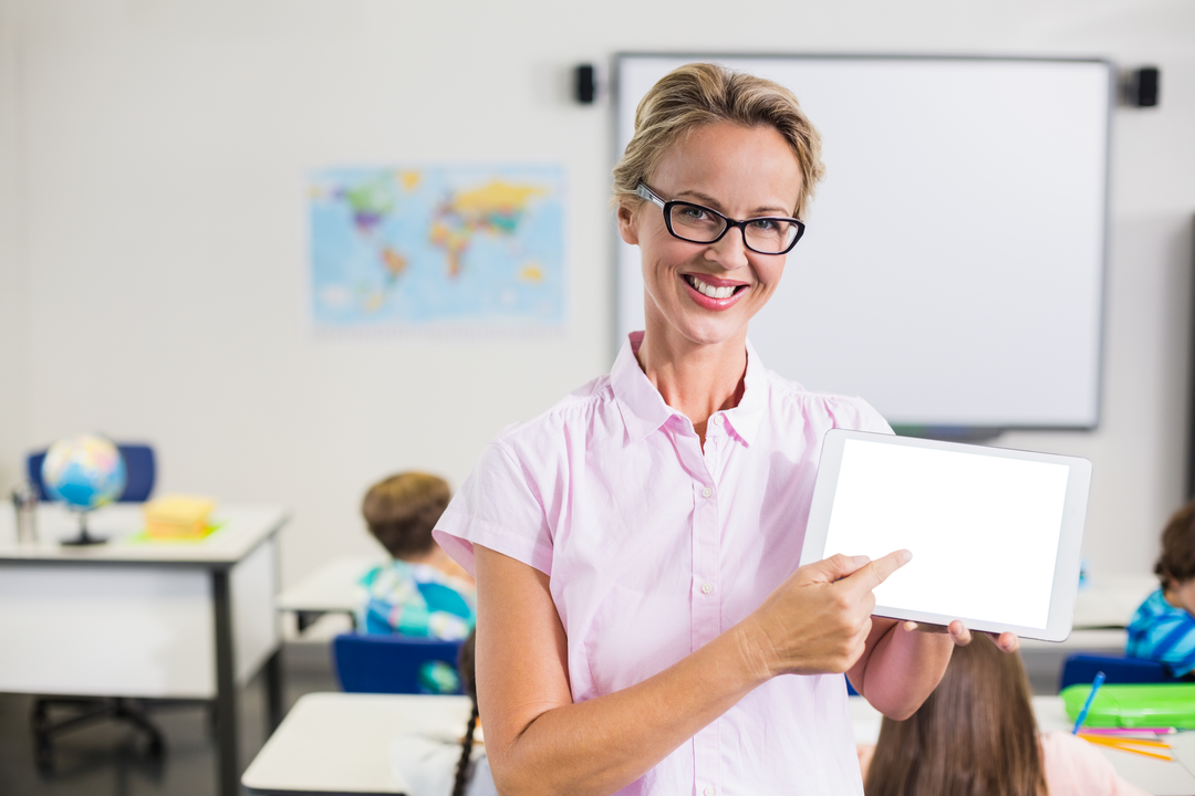 Transparent Tablet Being Presented By Smiling Female Teacher in Classroom - Download Free Stock Images Pikwizard.com