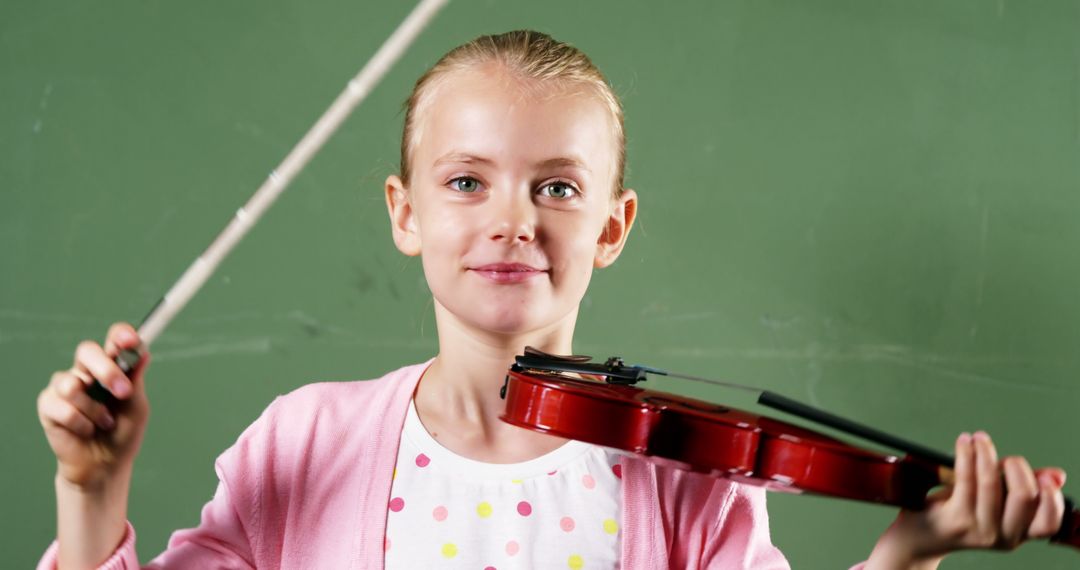 Smiling Schoolgirl Holding Violin in Classroom