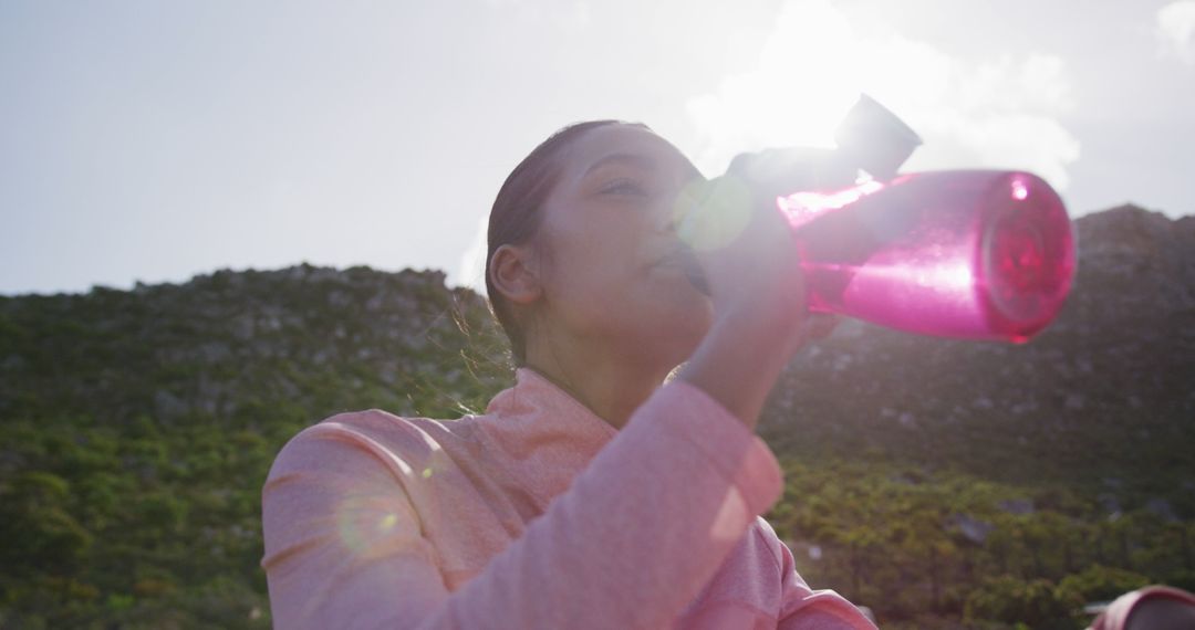 Young Woman Drinking Water Outdoors During Hike - Free Images, Stock Photos and Pictures on Pikwizard.com