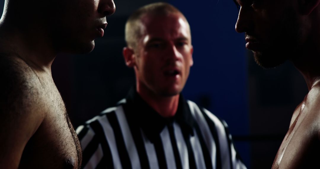 Intense Face-Off Between Determined Competitors with Referee in the Ring