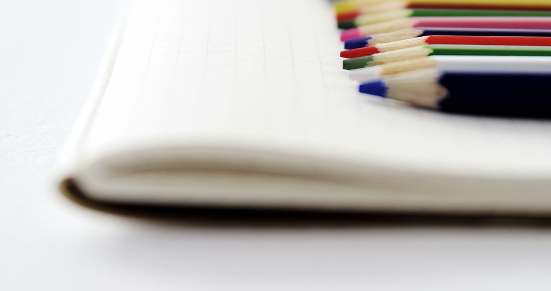 Close-Up of Colourful Pencils on Notebook - Free Images, Stock Photos and Pictures on Pikwizard.com