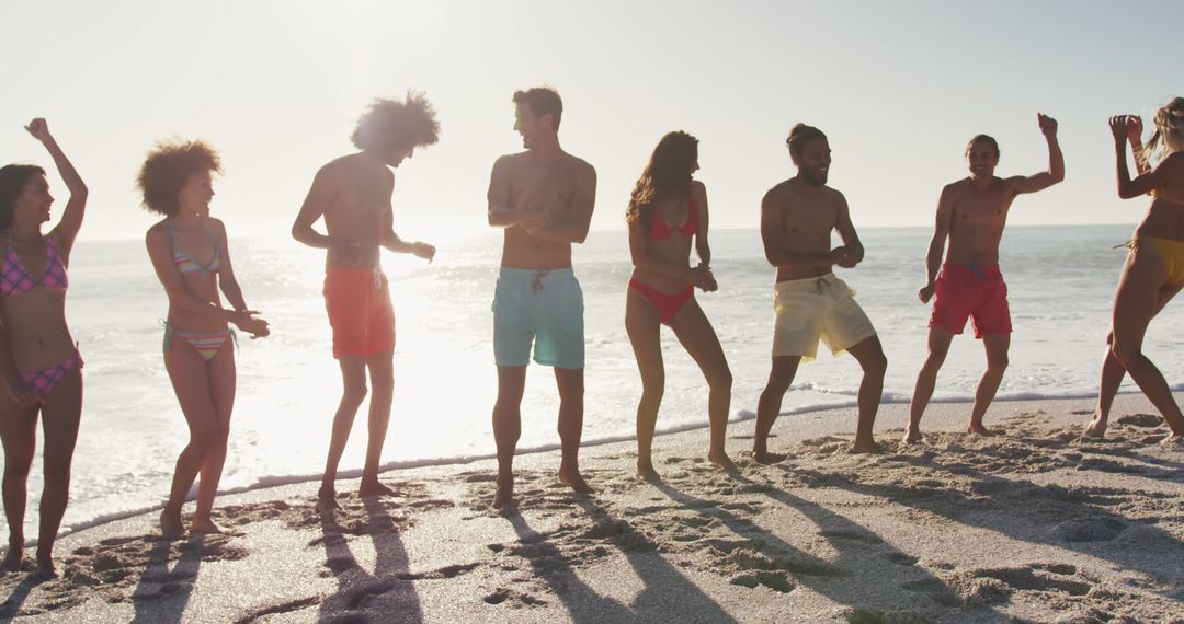 Diverse Group of Friends Dancing on Sunny Beach at Sunset - Free Images, Stock Photos and Pictures on Pikwizard.com