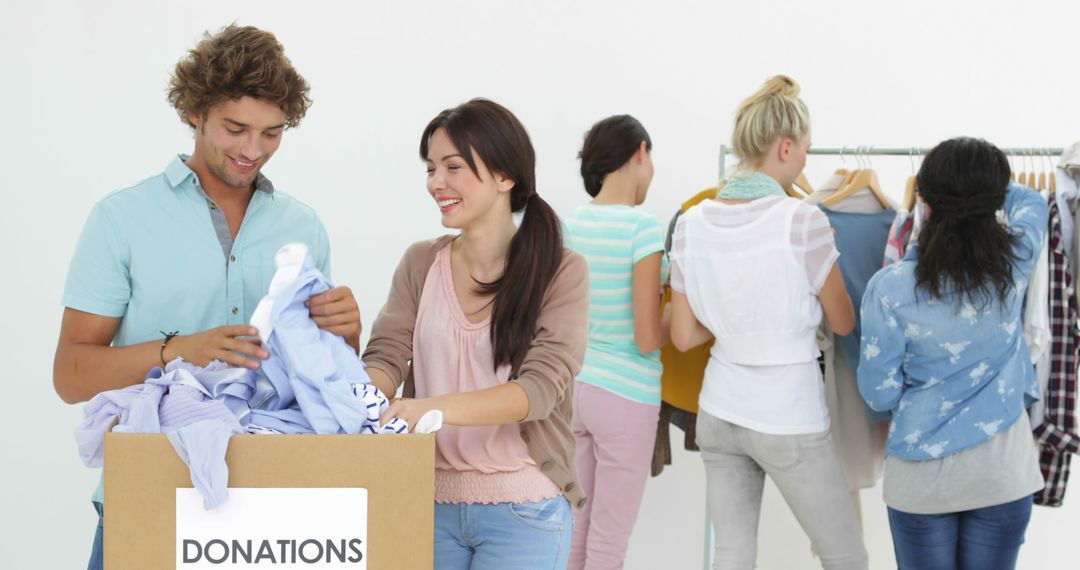 Volunteers Sorting Clothes for Donation in Community Center - Free Images, Stock Photos and Pictures on Pikwizard.com