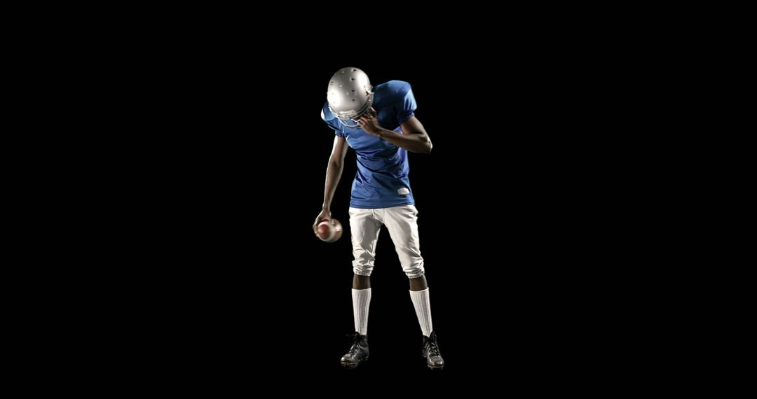 A contemplative African American teen in football gear pauses, possibly reflecting on defeat. - Free Images, Stock Photos and Pictures on Pikwizard.com