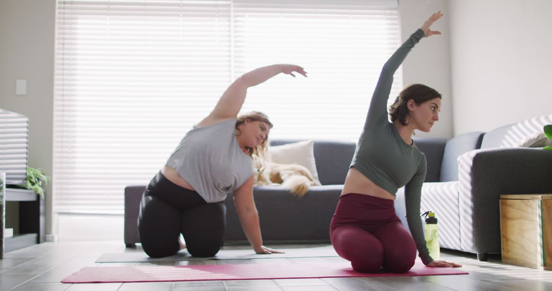 Two Women Practicing Yoga at Home in Bright Living Room - Free Images, Stock Photos and Pictures on Pikwizard.com