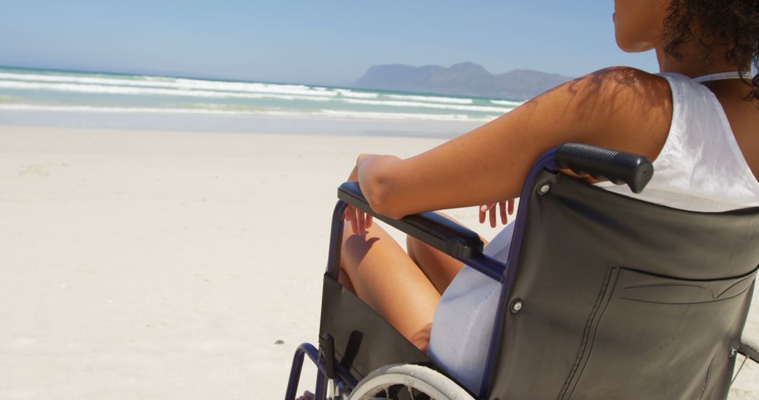 Person in Wheelchair Enjoying Sunny Day on Beach - Free Images, Stock Photos and Pictures on Pikwizard.com