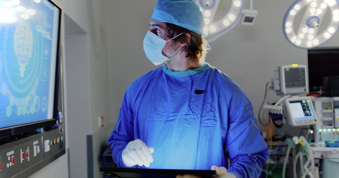 Surgeon in Operating Room Monitoring Digital Screen During Surgery - Free Images, Stock Photos and Pictures on Pikwizard.com