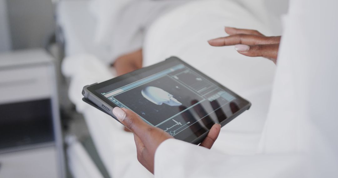 Doctor Examining Medical Scans on Tablet in Hospital - Free Images, Stock Photos and Pictures on Pikwizard.com