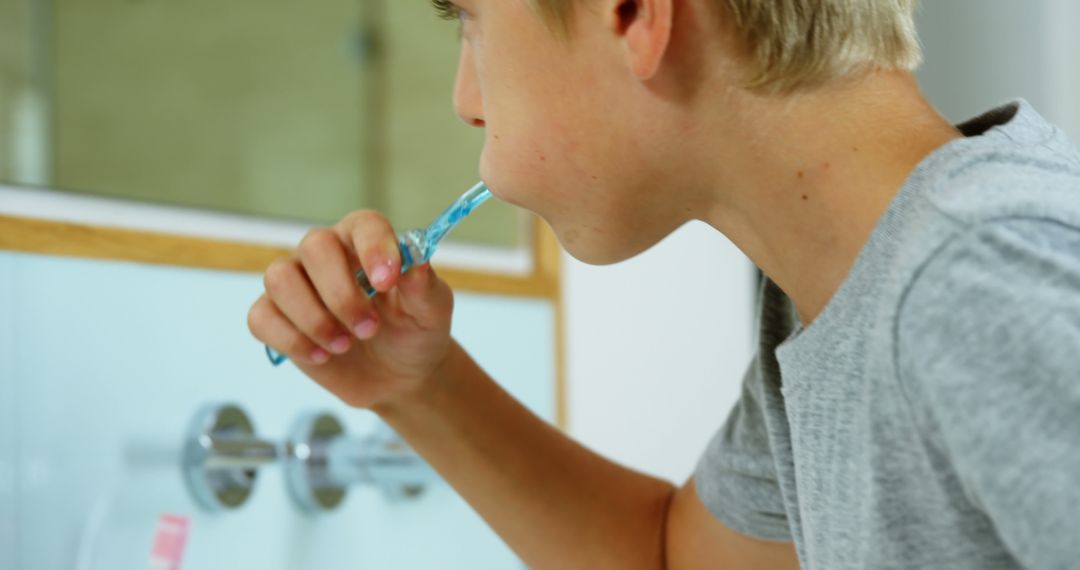 Blond Boy Brushing Teeth at Bathroom Sink in Morning Routine - Free Images, Stock Photos and Pictures on Pikwizard.com