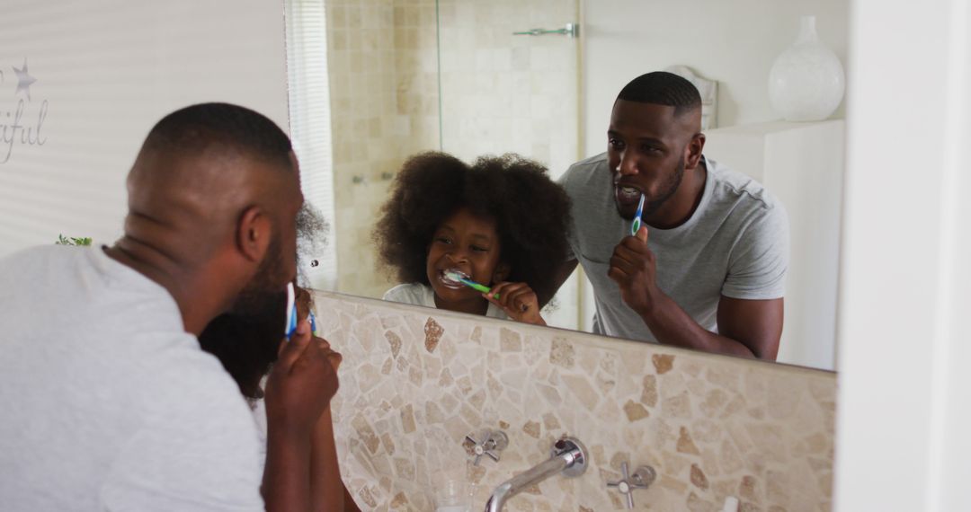 Happy Father and Daughter Brushing Teeth Together in Bathroom Mirror - Free Images, Stock Photos and Pictures on Pikwizard.com