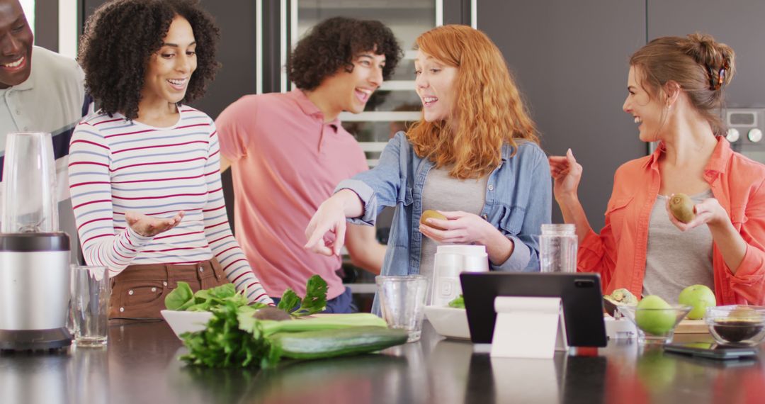 Group of Friends Joyfully Making Smoothies in Kitchen