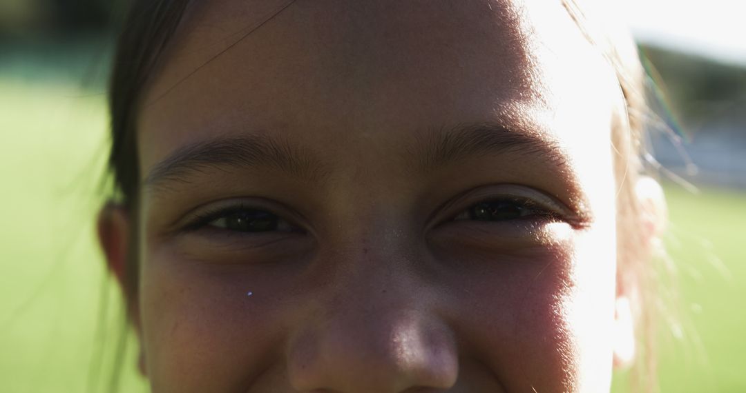 Close-Up of Smiling Child Outdoors with Sunlight - Free Images, Stock Photos and Pictures on Pikwizard.com