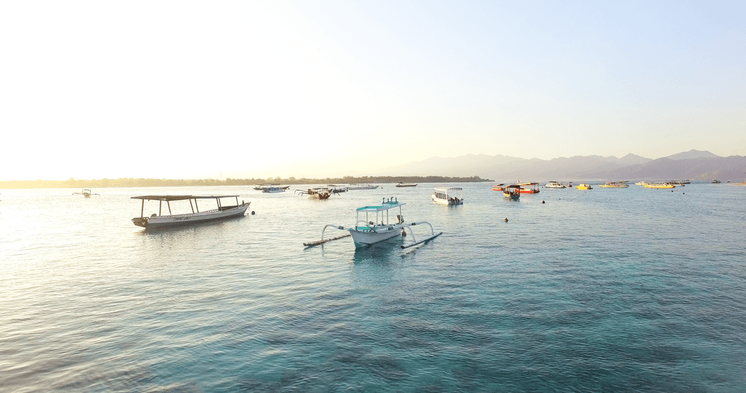 Tranquil Boats on Transparent Lake During Serene Sunset