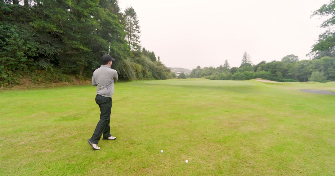 Golfer on Fairway Preparing Shot with Precision on Lush Green Course