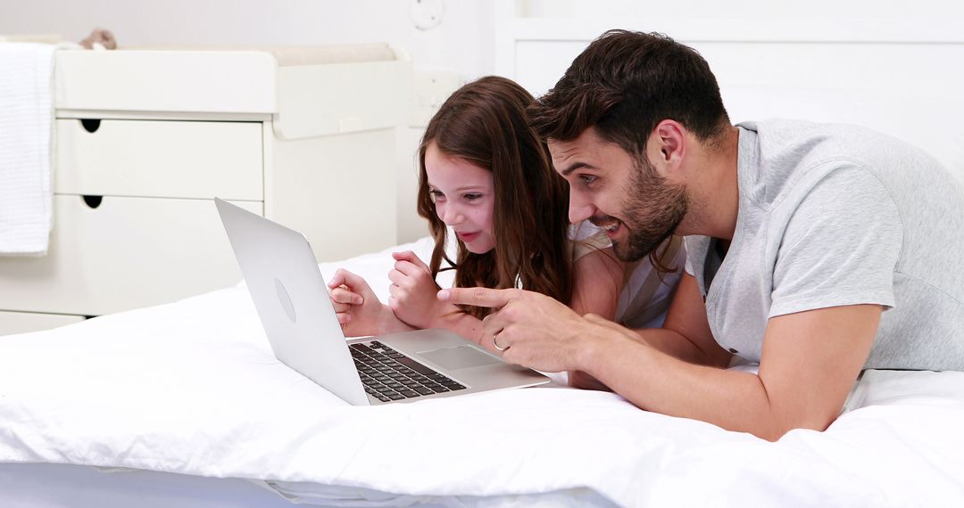 Father and Daughter Learning Together on Laptop in Cozy Bedroom - Free Images, Stock Photos and Pictures on Pikwizard.com